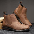 Pair of brown leather boots on a dark gray background