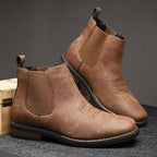 Pair of brown leather boots on a dark gray background